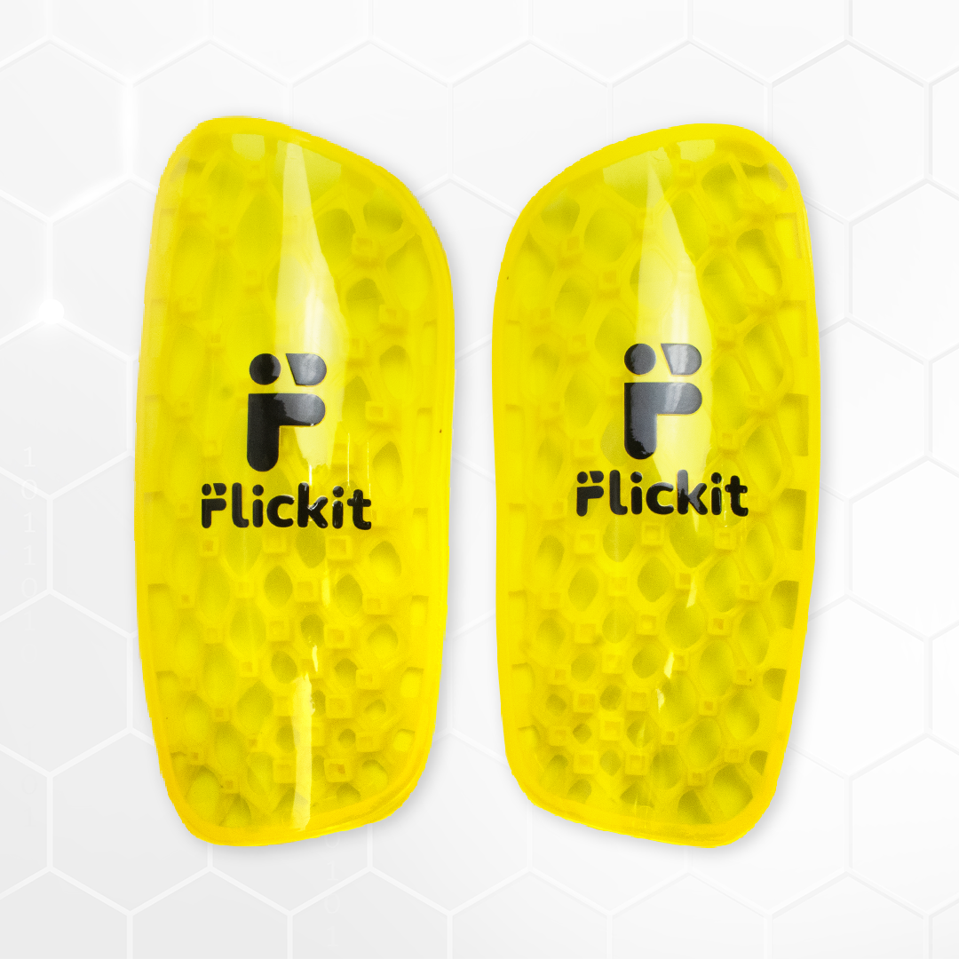 Pair of yellow shin guards with 'Flickit' branding on a white background
