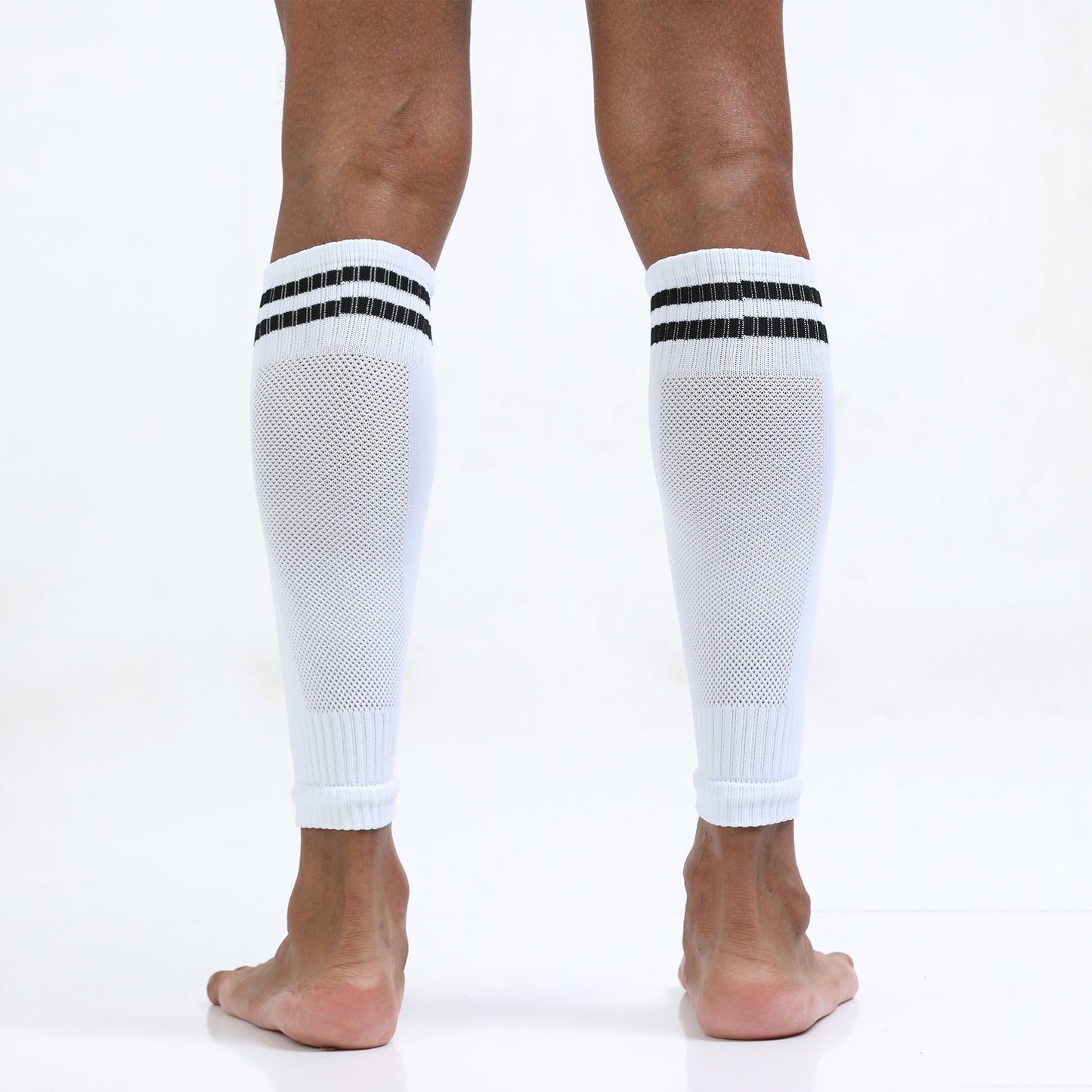 White knee-high socks with black stripes worn by a person on a white background