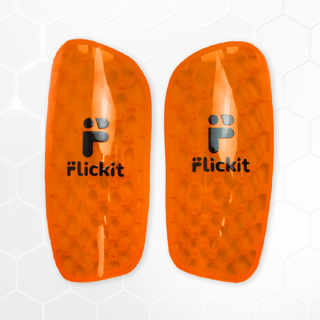 Pair of orange shin guards with 'Flickit' branding on a white background