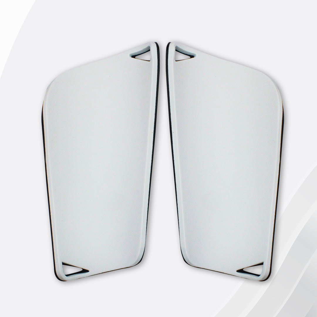 Pair of white hockey goalie leg pads on a light gray background