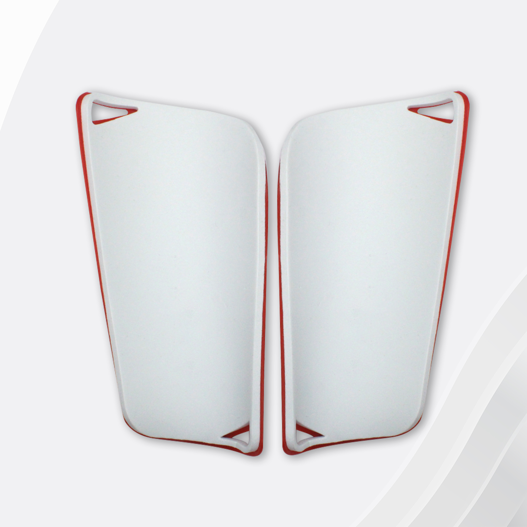 White shin guards with red accents on a white background