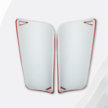 White shin guards with red accents on a white background
