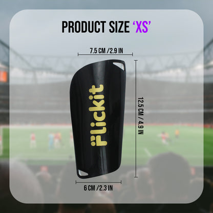 Black shin guard with 'Flickit' branding and measurements on a blurred sports field background