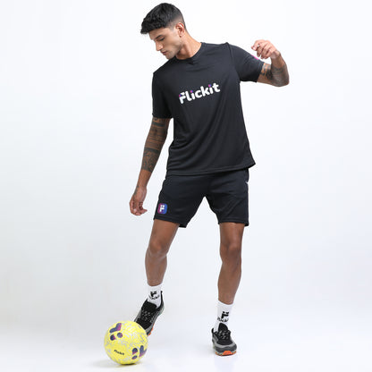 Person wearing a black 'Flickit' t-shirt and shorts with a soccer ball on a white background
