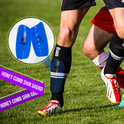 Person wearing blue honeycomb shin guards on a grassy field