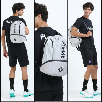 Person wearing a black t-shirt and shorts with a white drawstring bag labeled 'Flickit' on a white background.